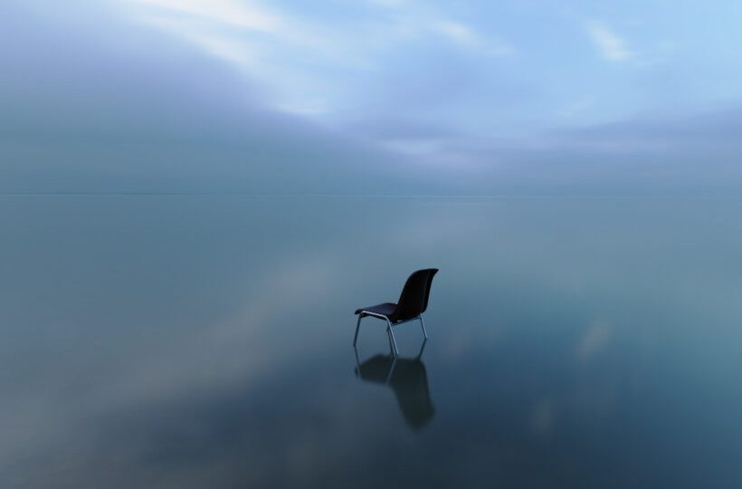 single-chair-reflecting-water-surface-stormy-day (1)
