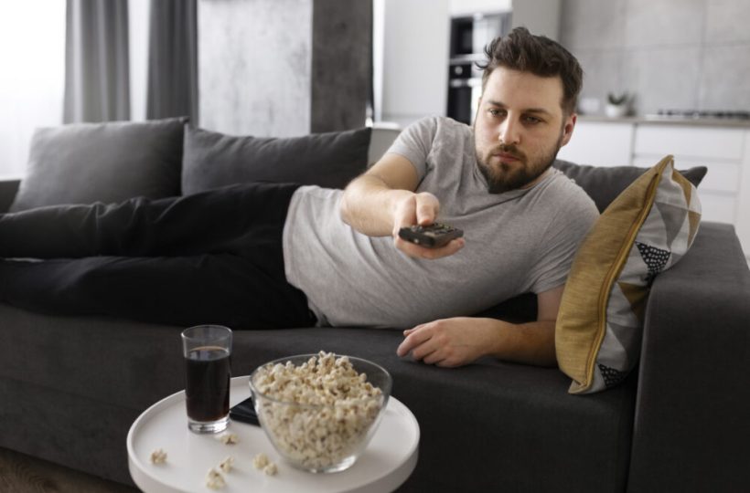 young-man-watching-tv-on-the-sofa-at-home